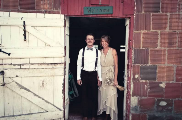 Wedding couple in front of barn doors