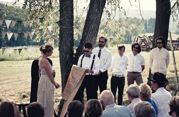 A rustic outdoor farm wedding ceremony 