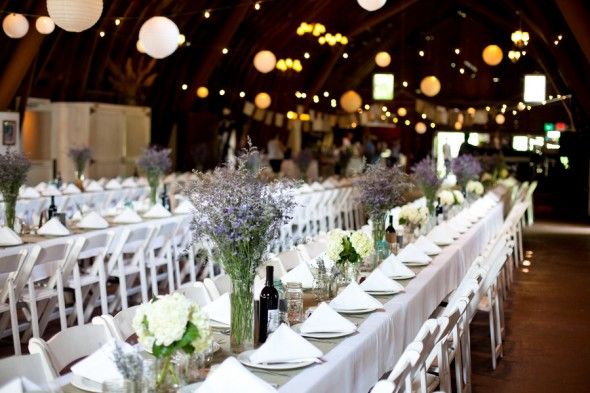 Long rustic wedding tables at a barn wedding