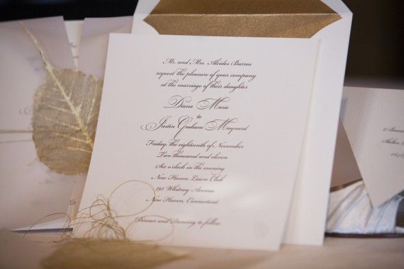 A gold and white wedding invitation 