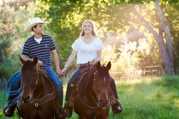 Engaged couple on horses 