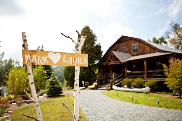 A rustic camp wedding with a birch sign