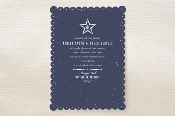 A silver and blue wedding invitation with a star