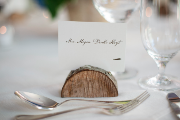 A wood wedding place card holder for a rustic wedding