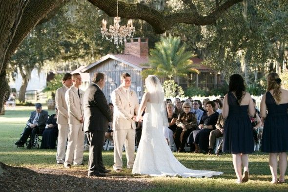 Country wedding ceremony outdoors with chandelier