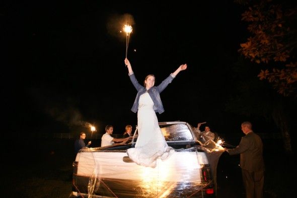 Country wedding bride with sparkler and denim jacket