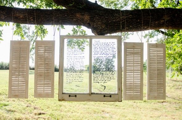 Backyard Wedding Ceremony Backdrop of Shutters and Windows with Wedding Vows Written On Them