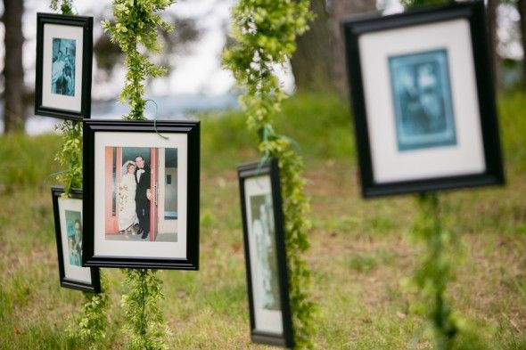 Framed Family Photos Hang from a Line at a Country Wedding