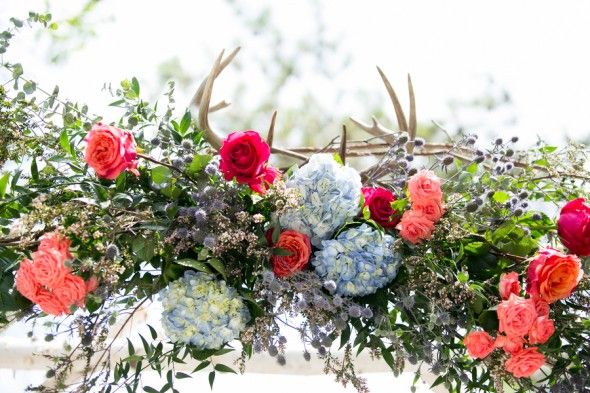 Flowers and Antlers on a Birch Wedding Arbor