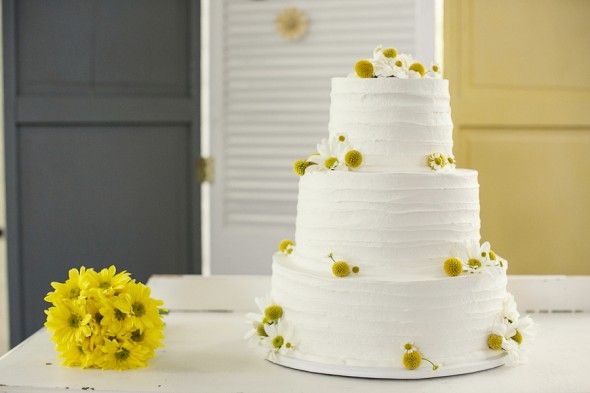 White Wedding Cake Decorated with Simple Yellow Flowers