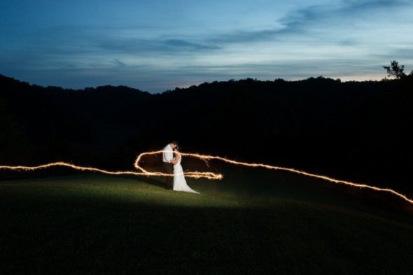 A Sparkler Illuminate the Bride and Groom