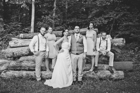 Wedding Party Pose on Timber Logs at Rustic Wedding Reception