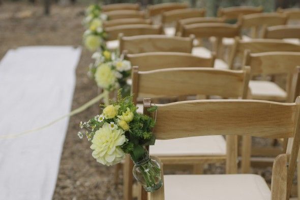 Chairs Decorated with Flowers for an Outdoor Wedding