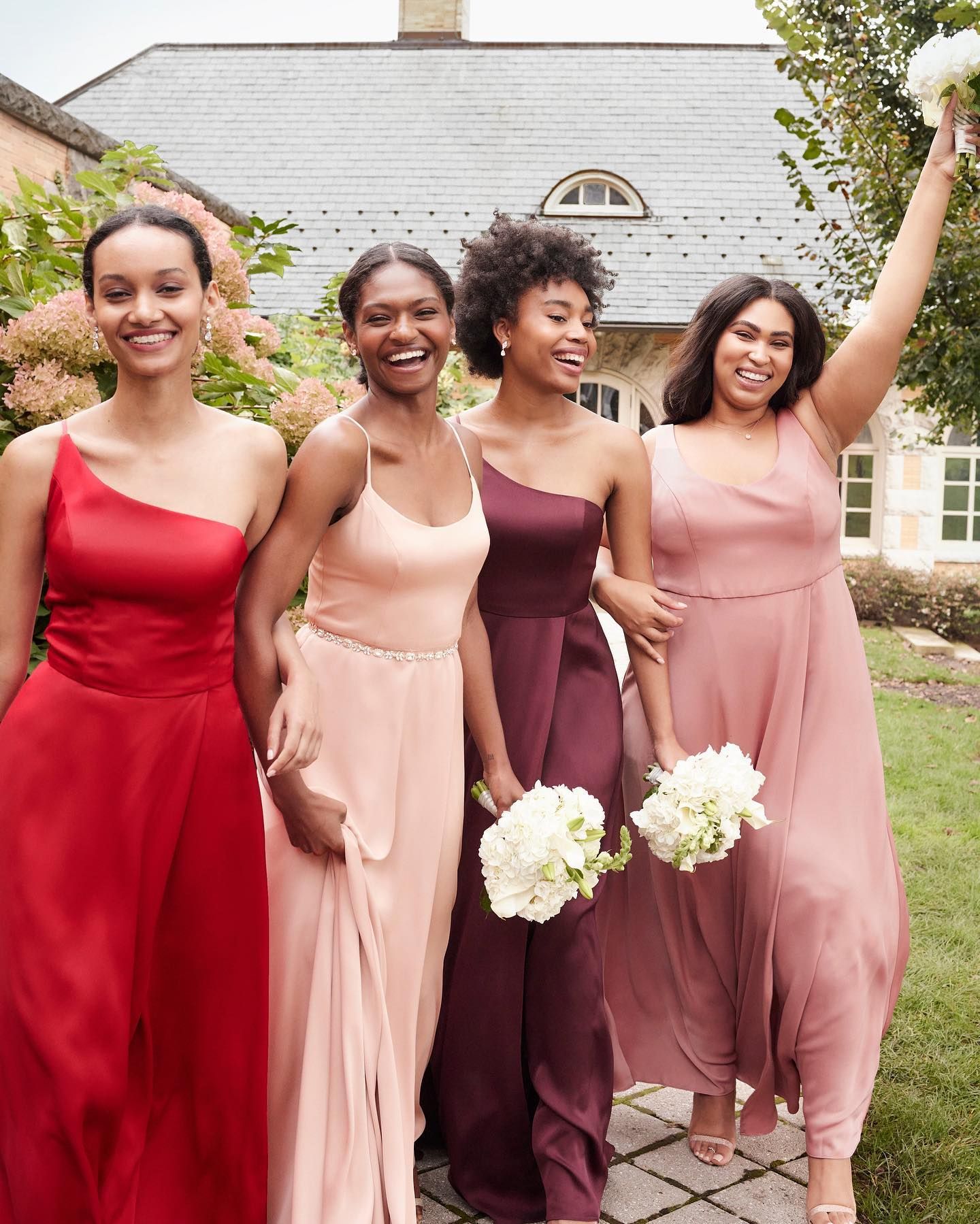 bridesmaids laughing in vibrant colored dresses
