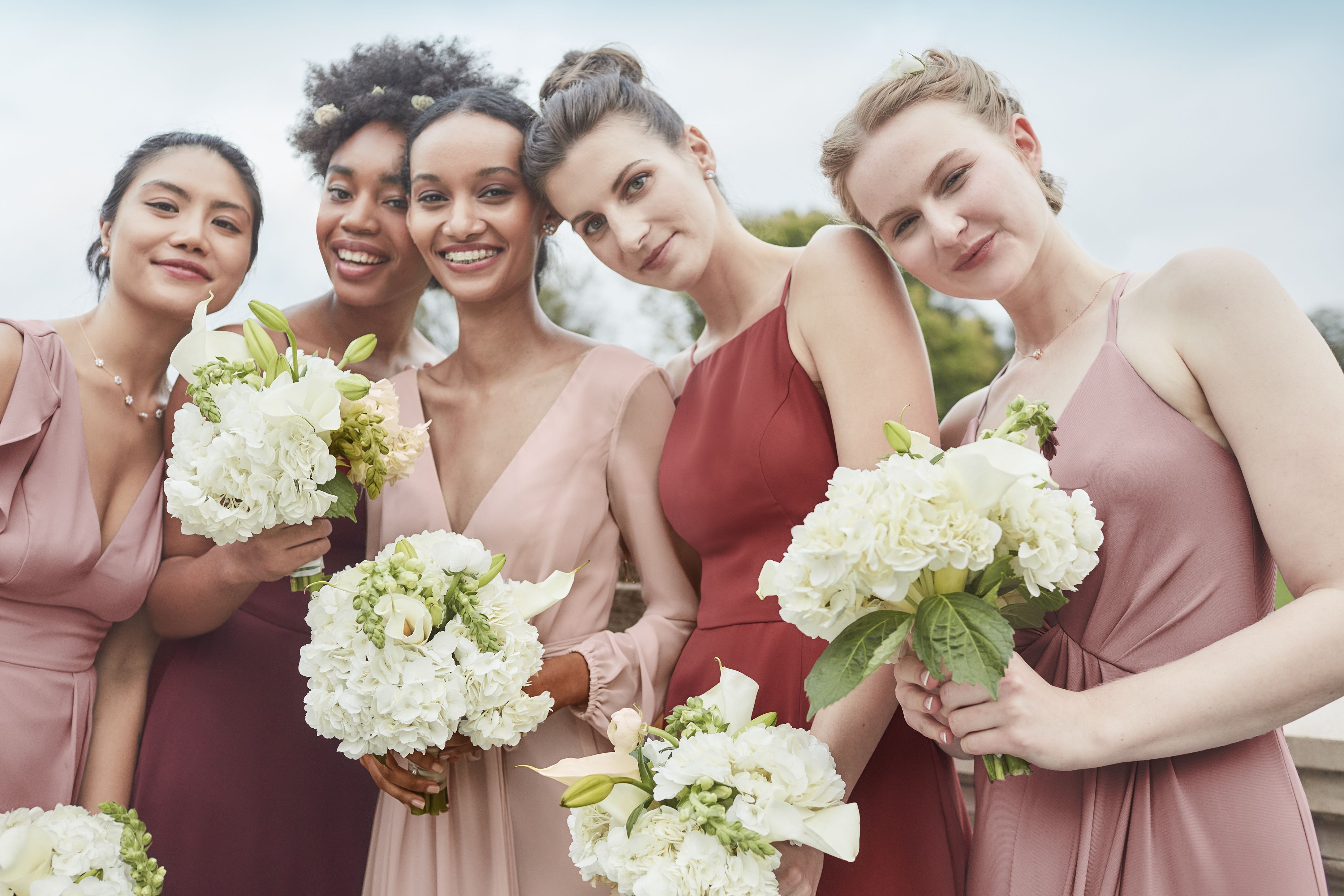 group of mix and match pink bridesmaids