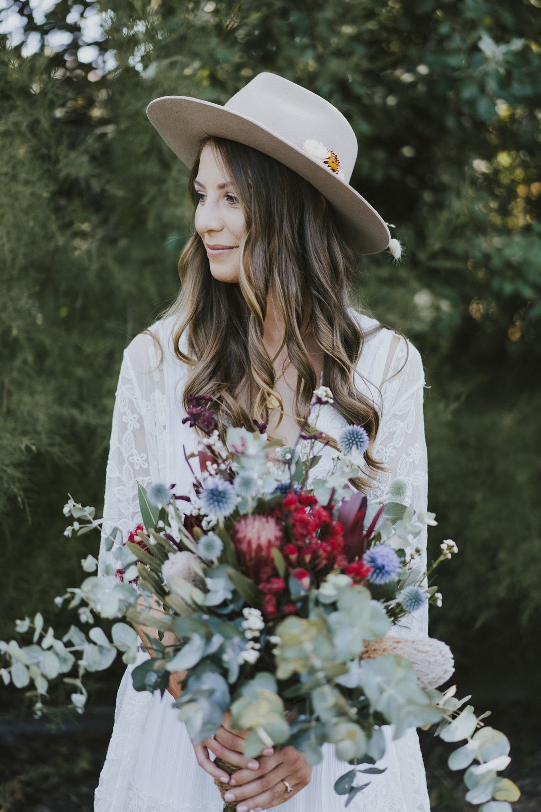 boho bride with loose curls and hat accessory