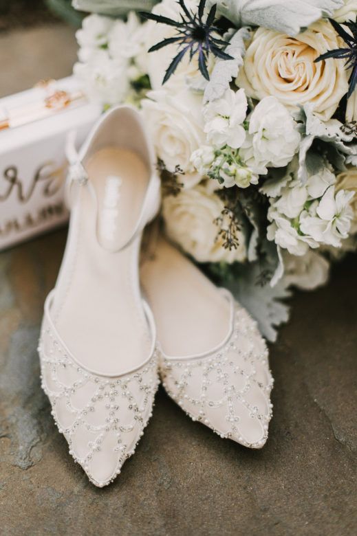 Bridal shoes displayed with bouquet