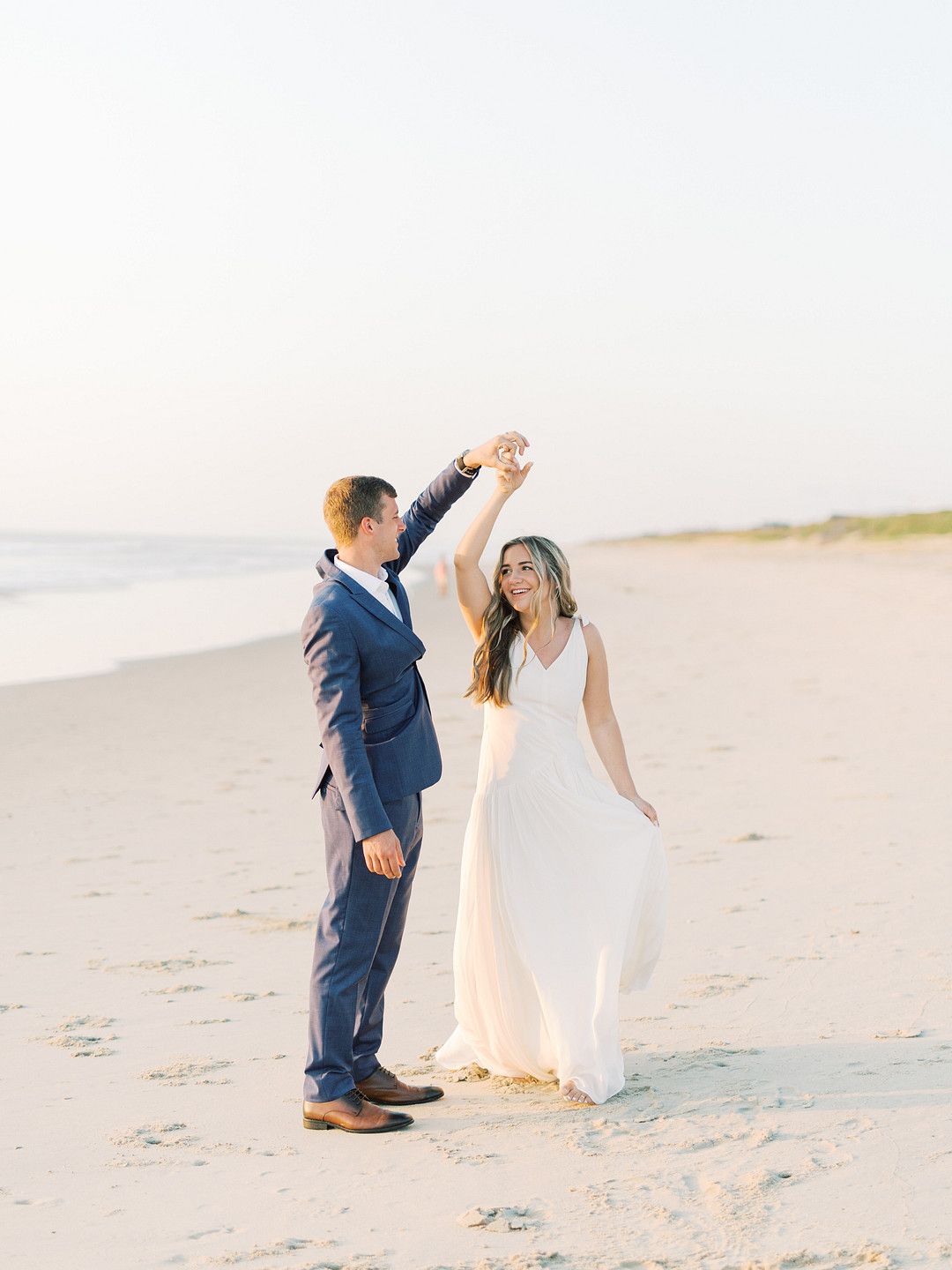 bride and groom dancing on the beach 
