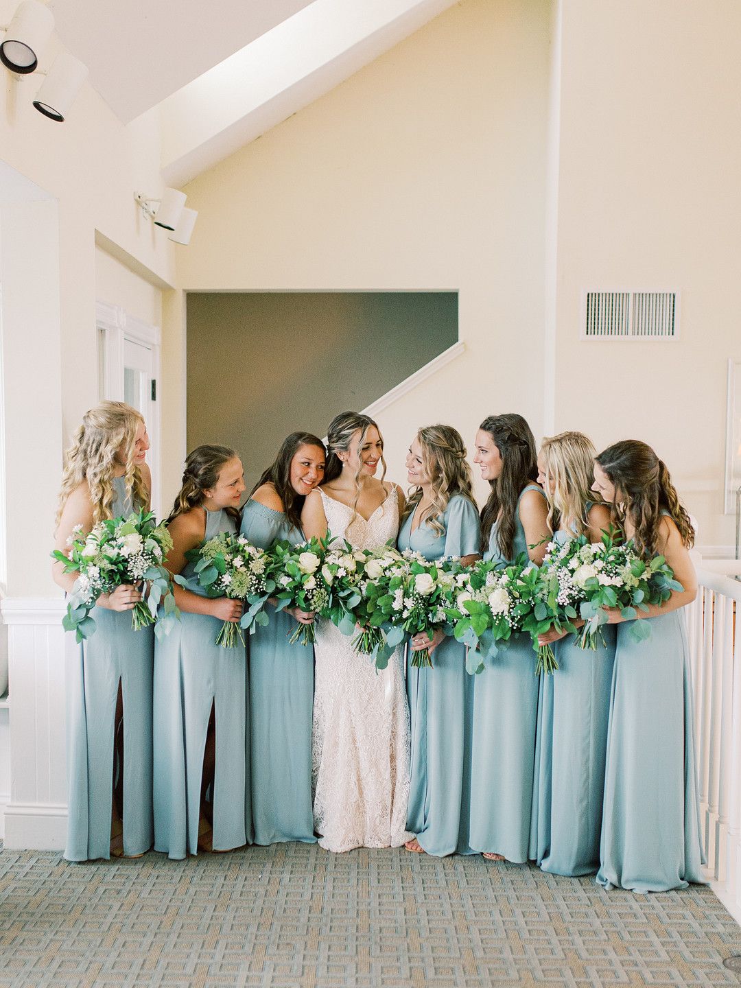 bride with her bridesmaids in dusty blue sage dresses