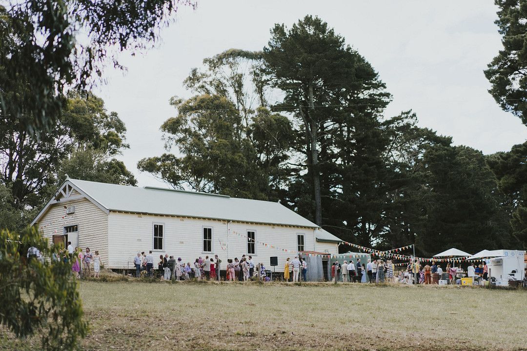 rustic wedding venue with guests outside