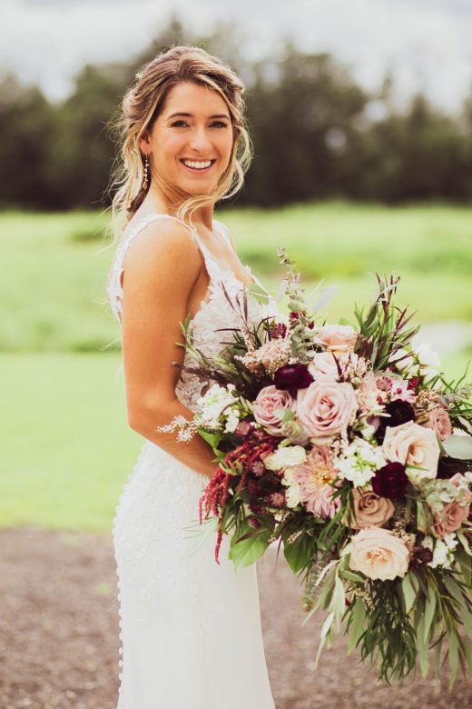 Bride smiling holding wedding bouquet