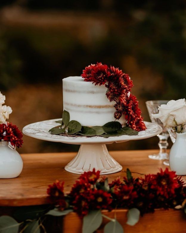 one tier wedding cake with red flowers