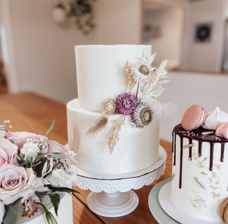 white wedding cake with dried flowers