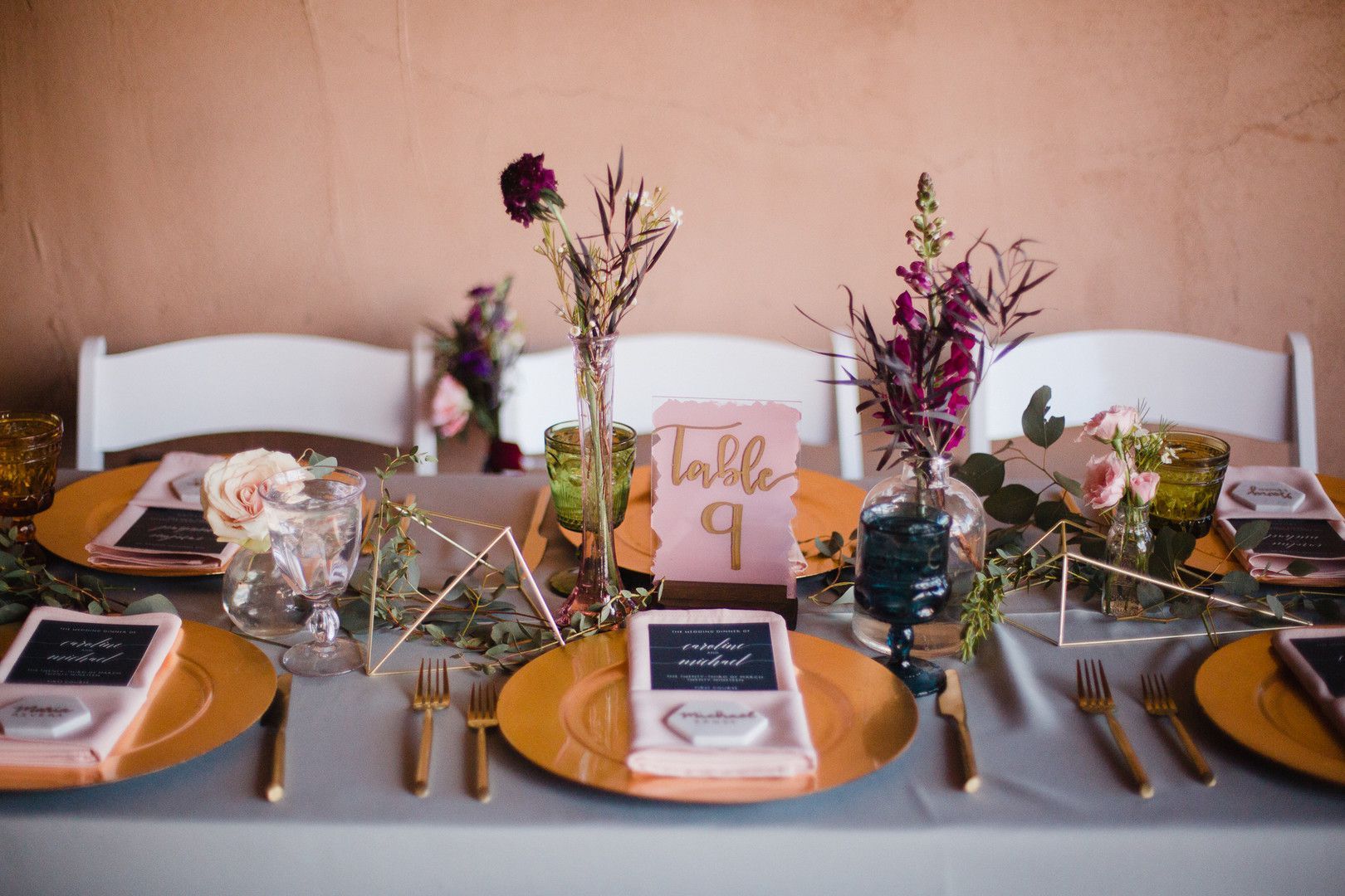 wedding table with gold dishware and pink blush accents