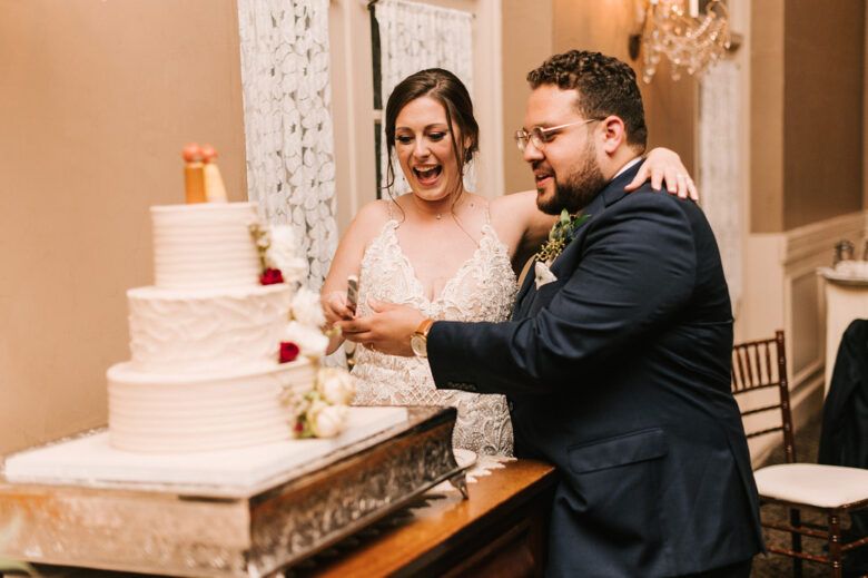 bride and groom cutting wedding cake