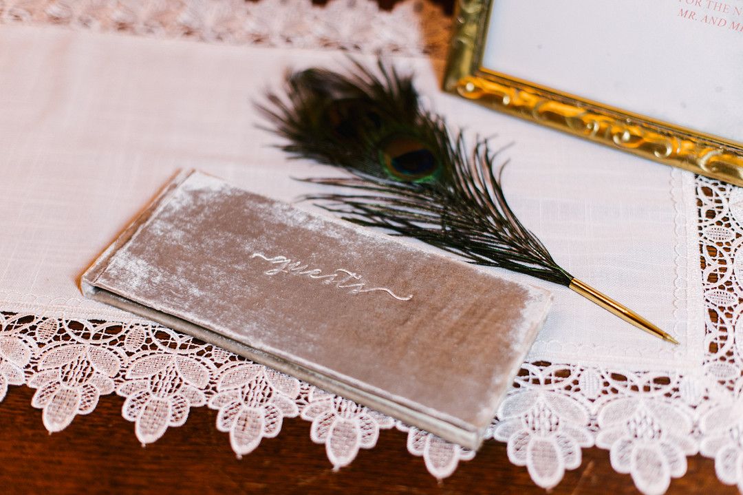 velvet wedding guestbook and feather pen