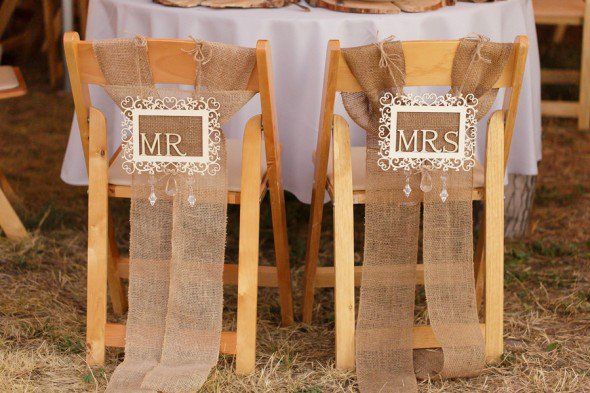 mr and mrs wedding signs with burlap fabric on the back of chairs