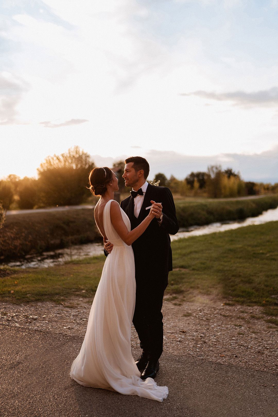 bride and groom dancing at golden hour
