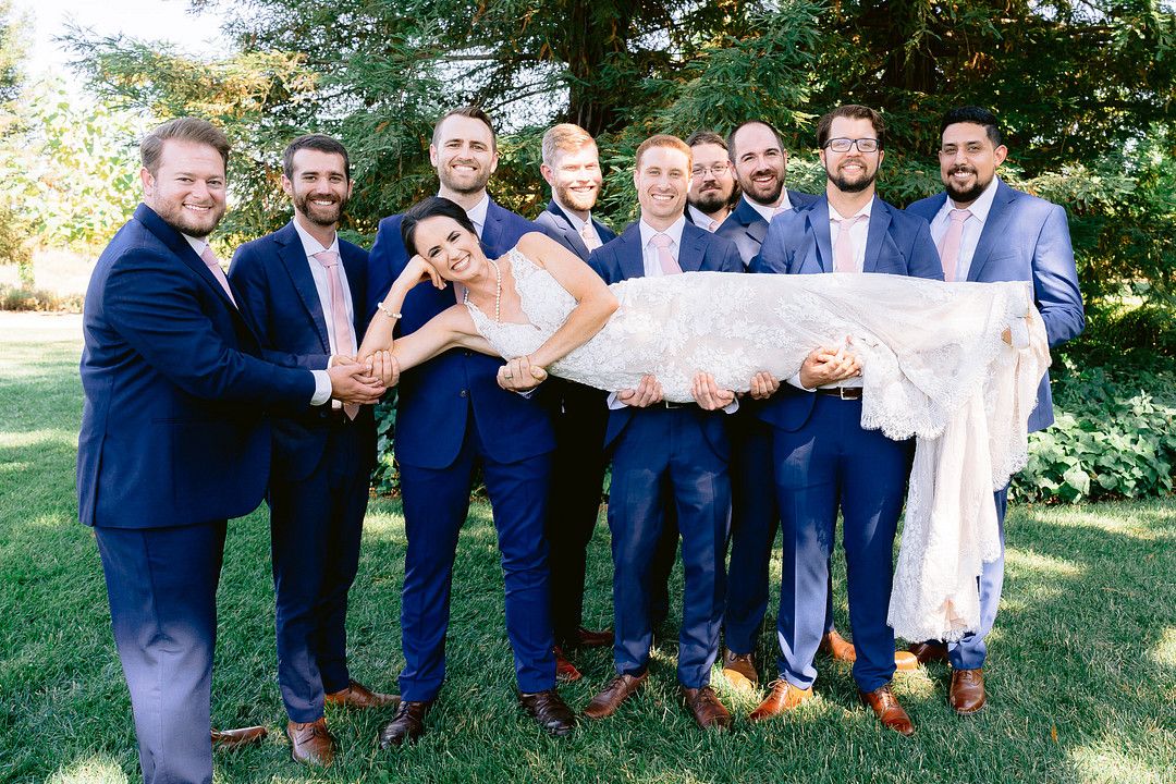 groomsmen holding bride
