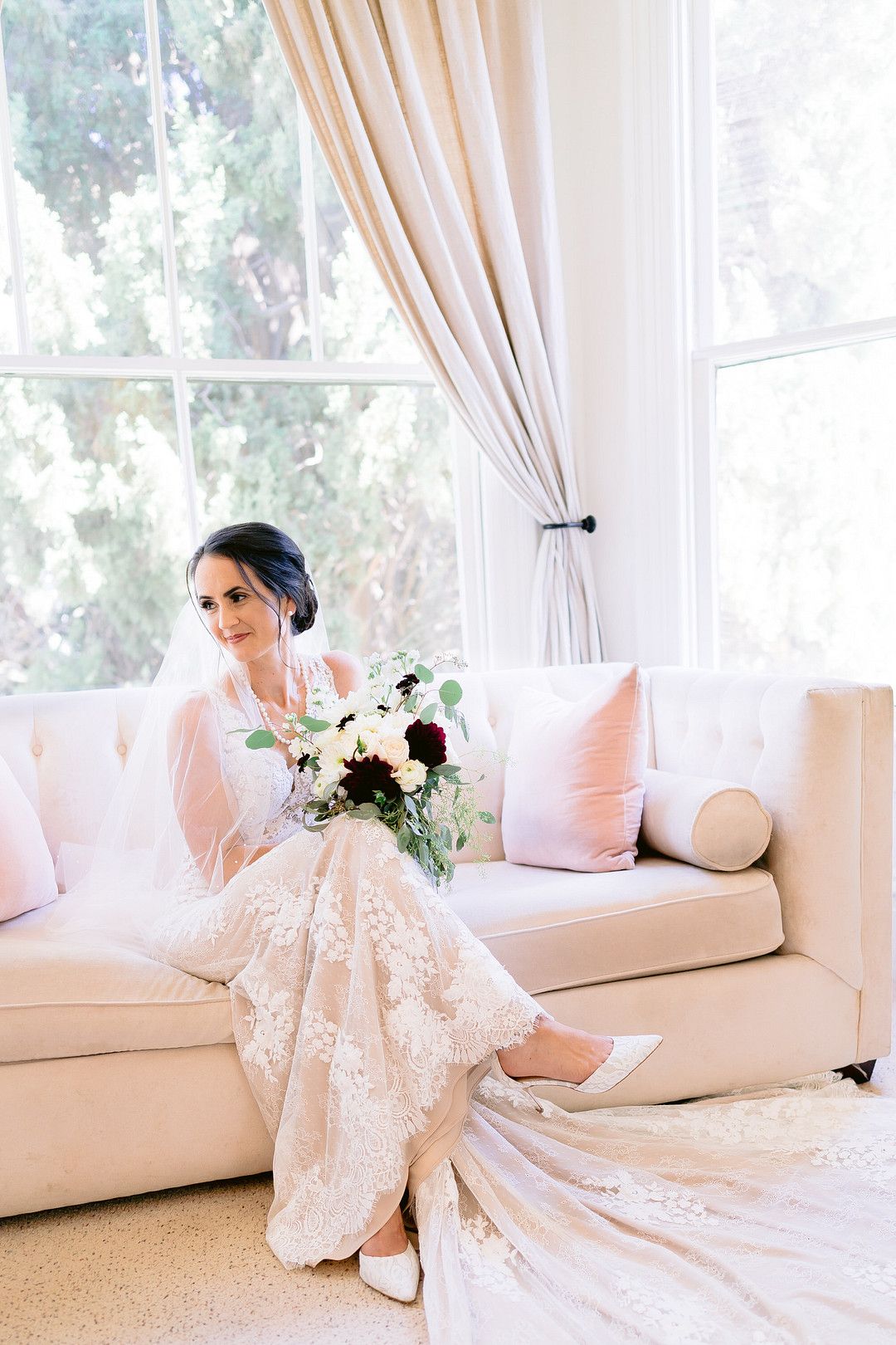 bride in wedding dress sitting on couch
