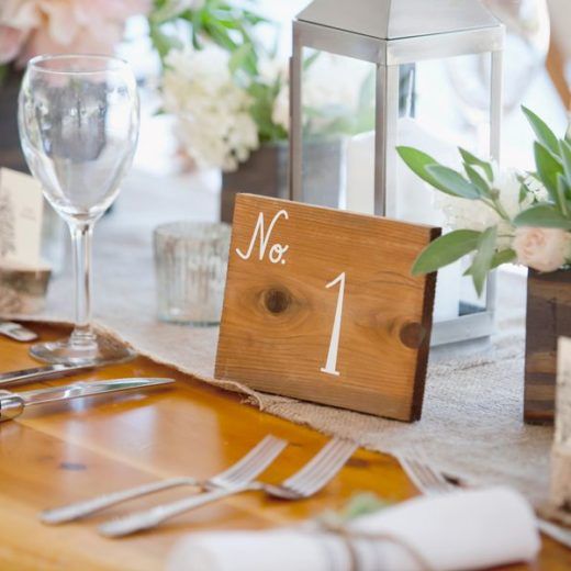 table number 1 written on wooden sign