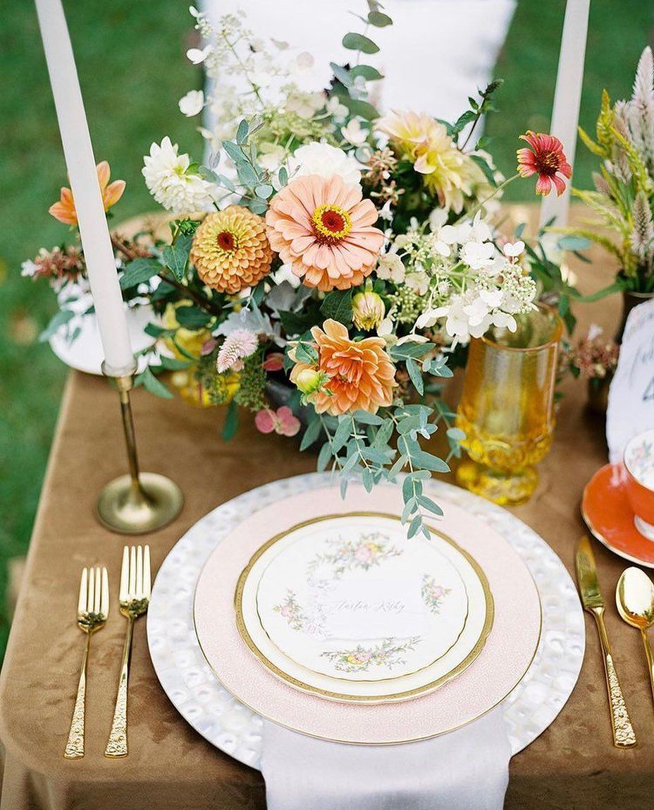 vintage tablescape with floral china and bright colored flowers