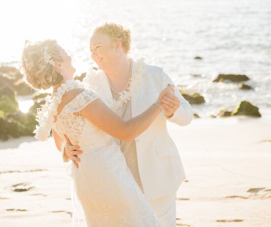 bride and bride dancing on the beach in maui