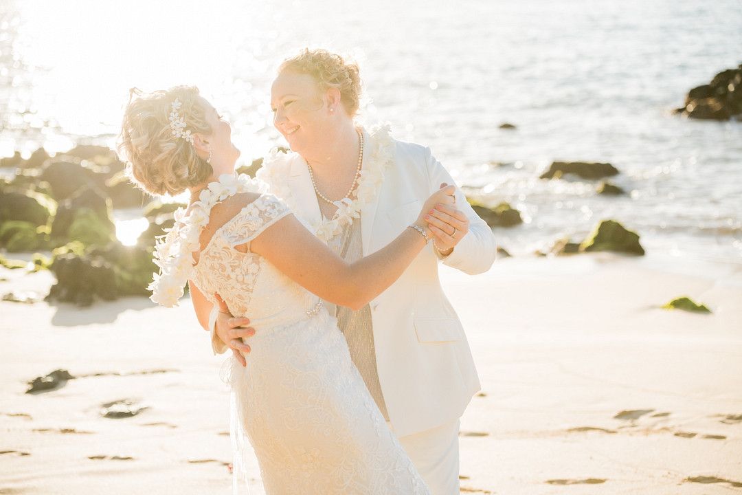 bride and bride dancing on the beach in maui