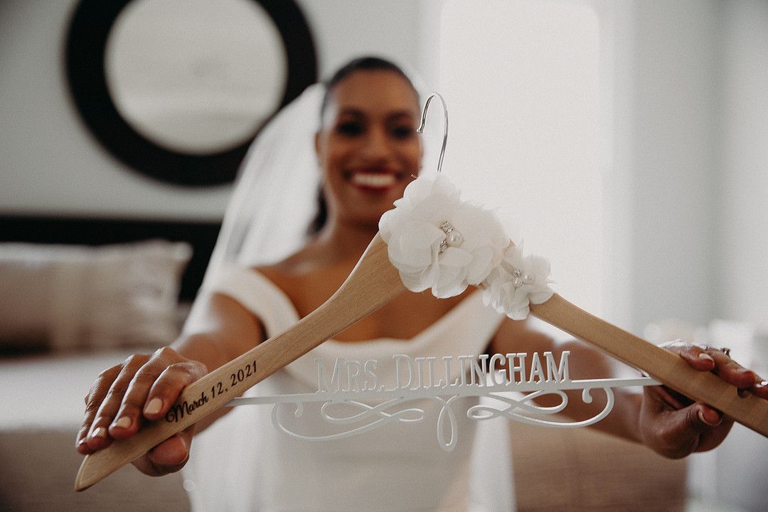 bride holding personalized hanger