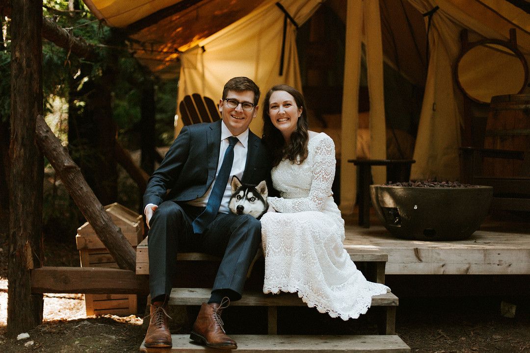 bride and groom sitting in tent