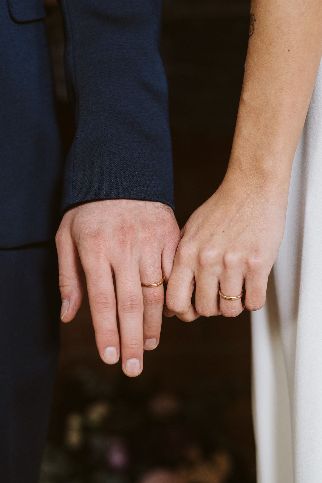 bride and grooms hands with rings on