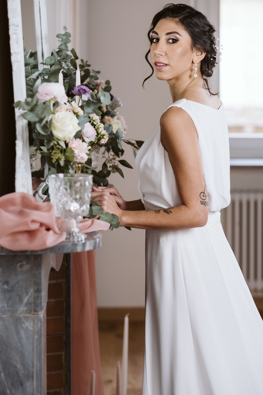 bride standing in front of fire place at at at home elopement