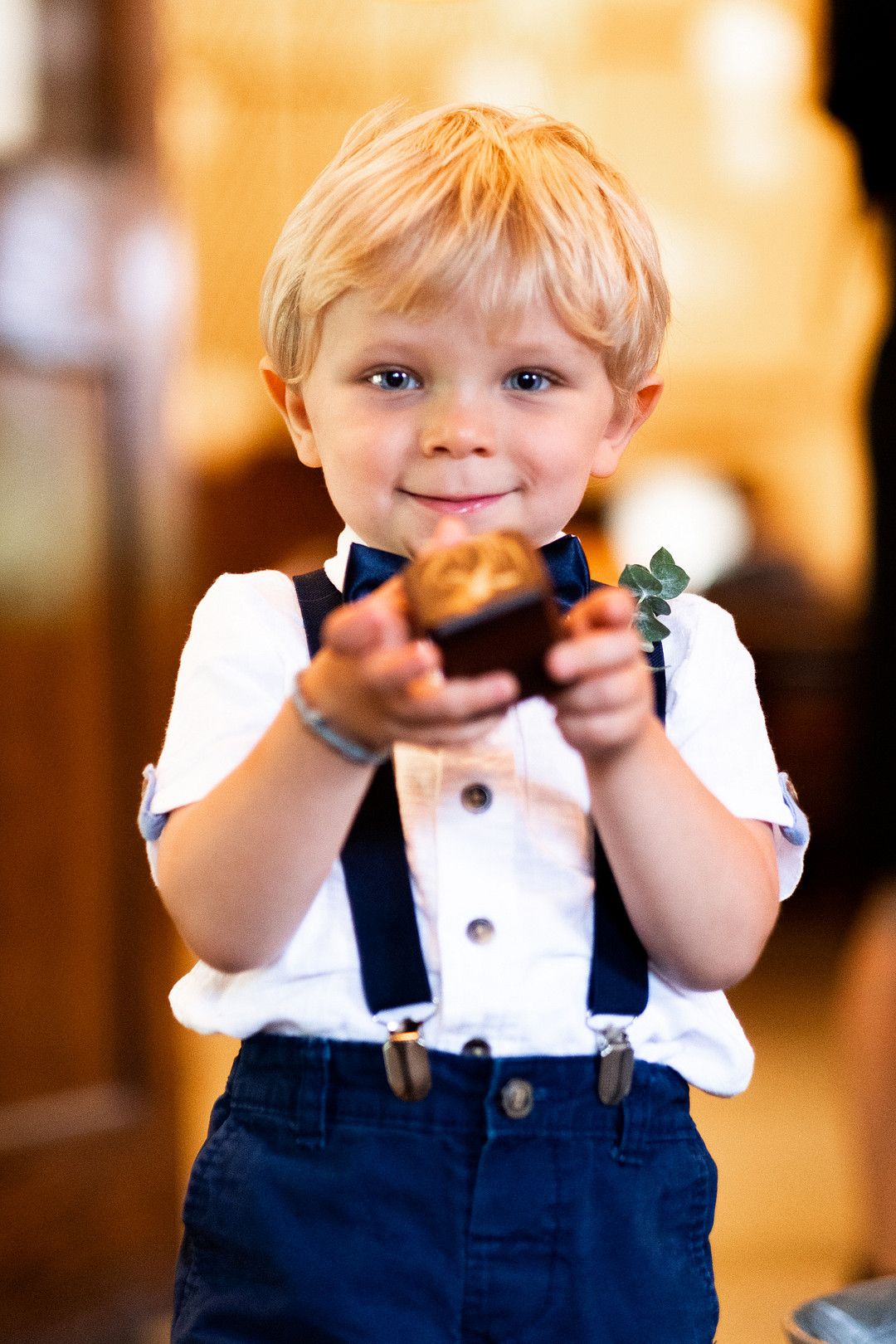 young ring bearer holding ring box 