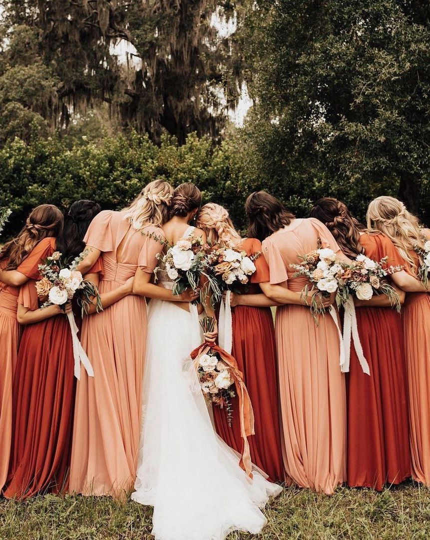 bridesmaids wearing vibrant colored wedding dresses