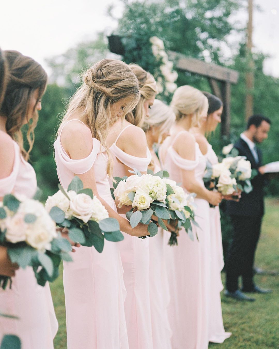 bridesmaids at rustic wedding wearing pastel pink dresses
