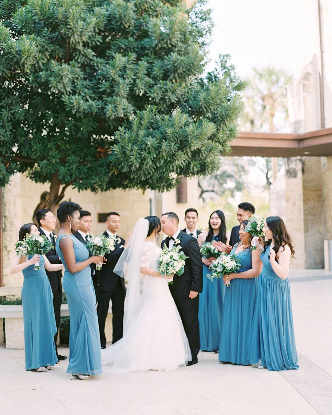 wedding party with bridesmaids wearing blue dresses