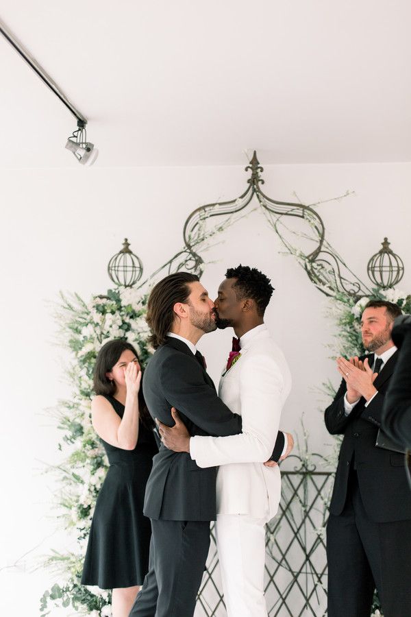 grooms kissing at at-home wedding