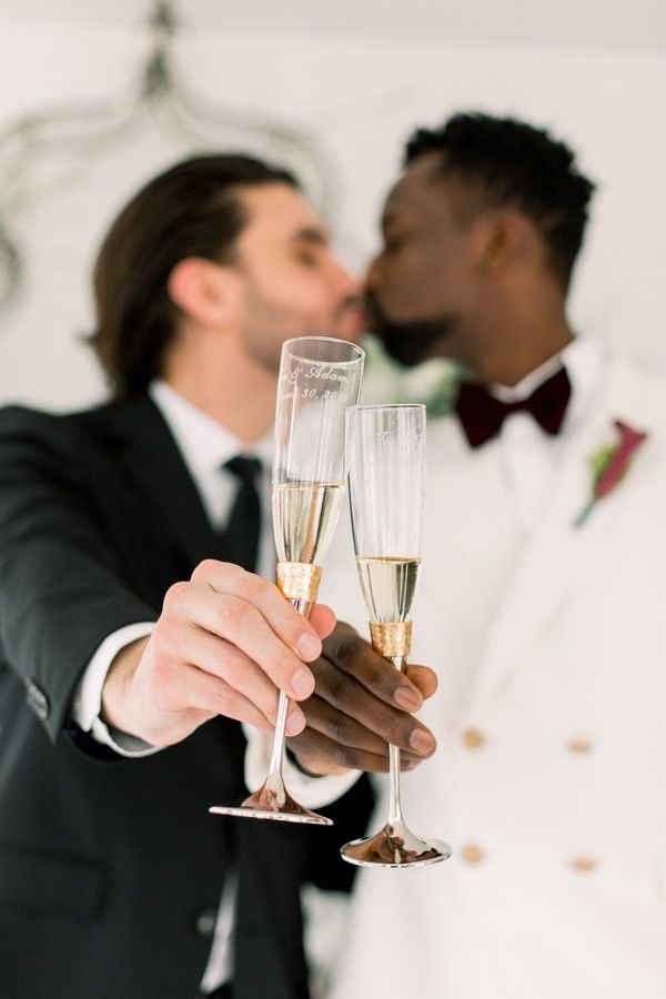 grooms cheersing and kissing