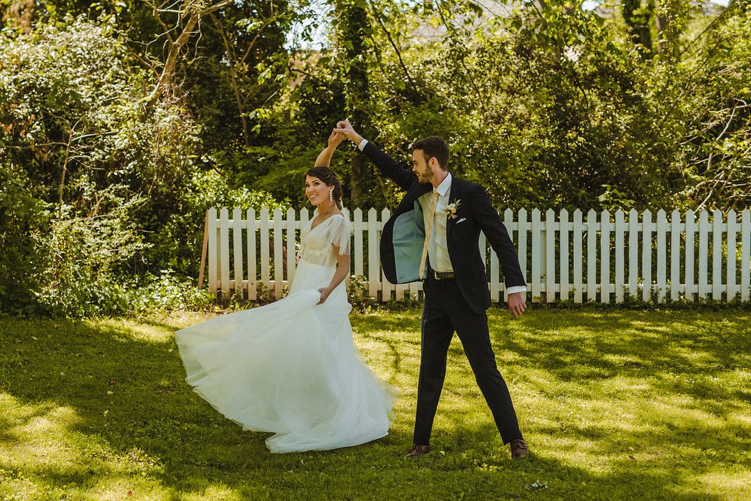 groom twirling bride at whimsical garden wedding inspiration shoot
