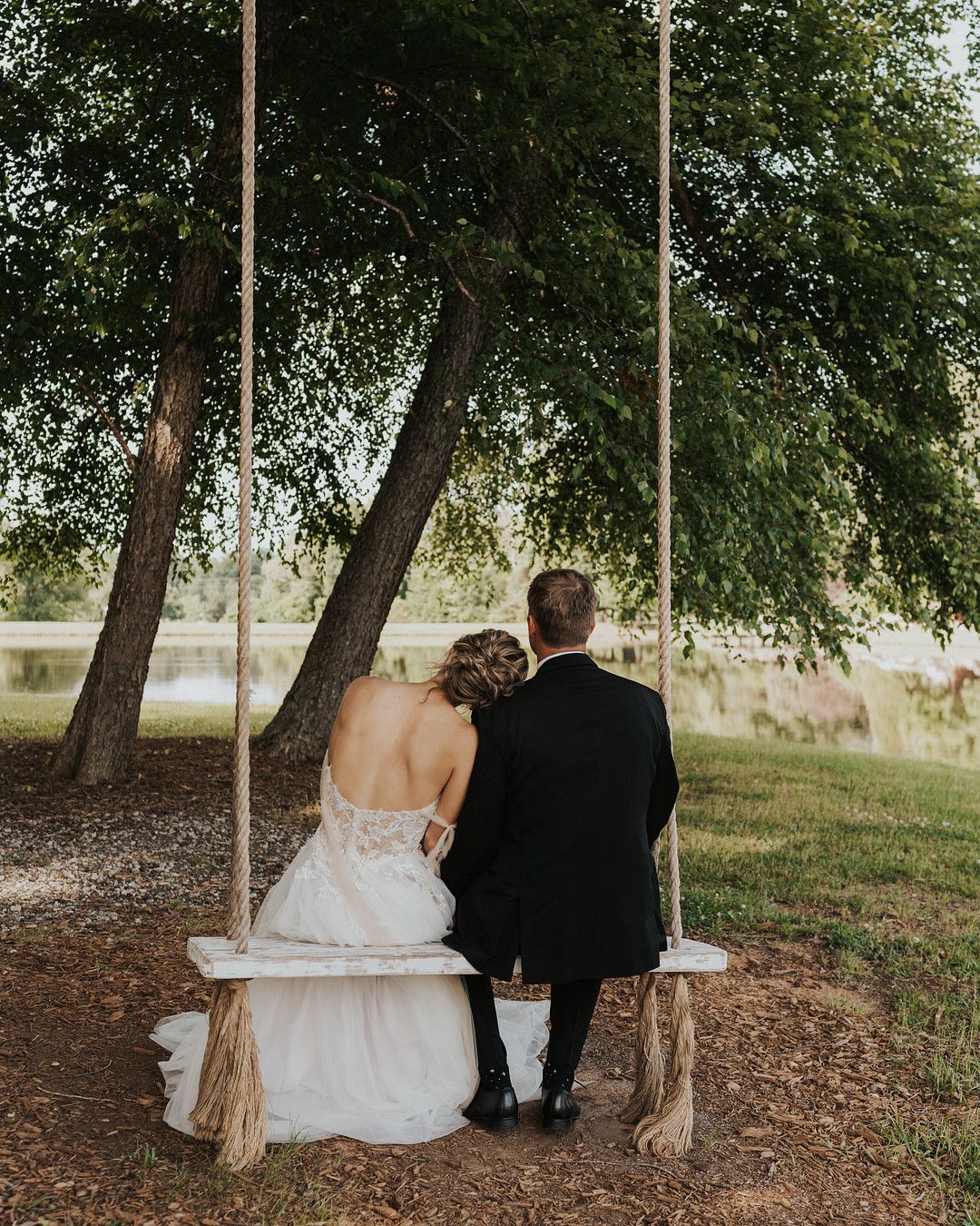 bride and groom on a swing in romantic wildflower inspiration shoot